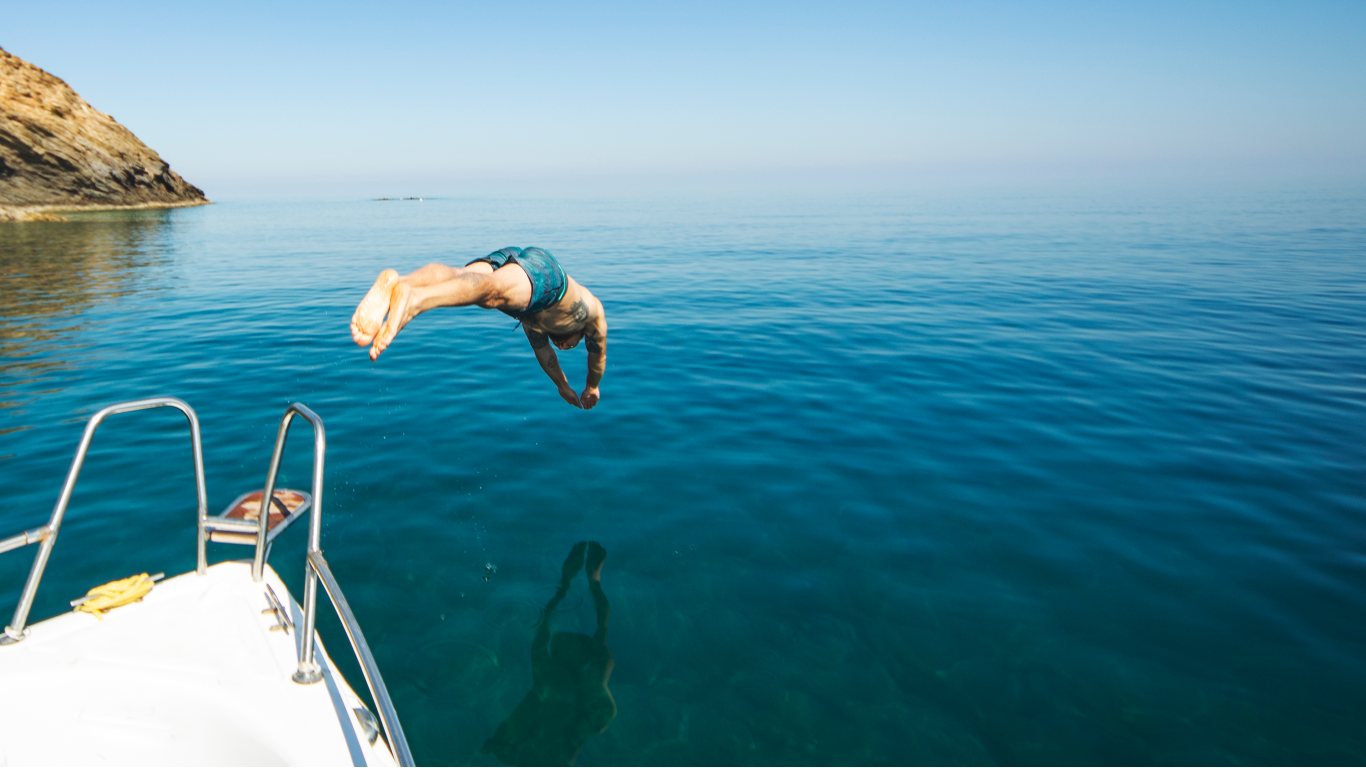 Man diving off a boat into the ocean